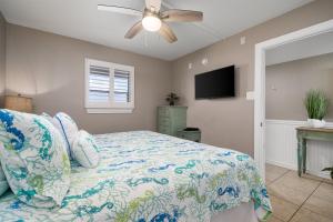 a bedroom with a bed and a ceiling fan at LR 213 - Four Point Lighthouse in Rockport