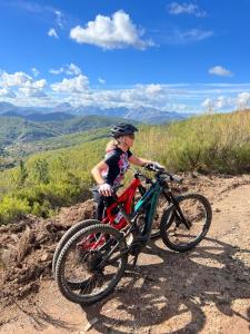 a little girl riding a bike on a dirt road at Casa Rural La Costurera in Los Espejos de la Reina +13 photos