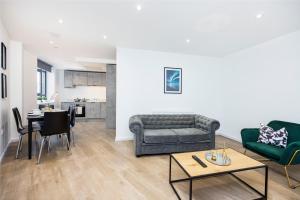 a living room with a couch and a table at The Old Court House Apartments in Luton