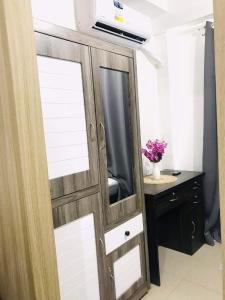 a sliding door with a mirror and a desk at Mall of Asia Condotel Pasay Philippines in Manila