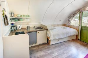 a small kitchen with a sink and a bed in a room at Finest Retreats - Humbleton Glamping in Hexham