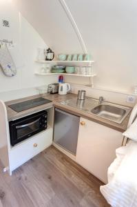 a small kitchen with a sink and a microwave at Finest Retreats - Humbleton Glamping in Hexham