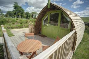 a gazebo with a green door on a deck at Finest Retreats - Humbleton Glamping in Hexham