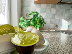 a cup of coffee on a plate on a kitchen counter at Villetta a schiera con giardino - Val Trebbia 