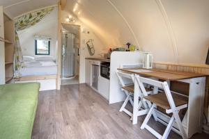 a kitchen and dining room with a table and a refrigerator at Finest Retreats - The Wonneys Glamping in Hexham