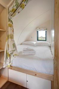 a bed in a small room with a window at Finest Retreats - Wheatleys Glamping in Hexham