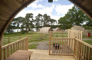 a view of a farm with a fence and a wooden deck at Finest Retreats - The Rushy Lot in Hexham