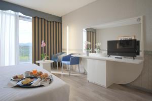 a hotel room with a tray of food on a table at Hotel Viest in Vicenza