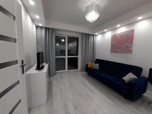 Televízia a/alebo spoločenská miestnosť v ubytovaní Welcome Apartment