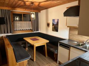 cocina pequeña con mesa y mesa pequeña en Apart Dorfbäck, en Kaunertal