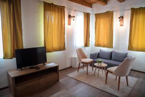 a living room with a blue couch and chairs at Varo&scaron; Čar&scaron;ija in Trebinje