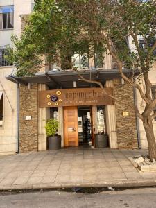 a building with a sign on the front of it at Mapungubwe Hotel Apartments Marshalltown in Johannesburg