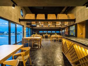 a restaurant with tables and chairs and a view of the ocean at Vinárstvo Predium Vráble in Vráble