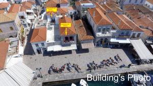 an overhead view of a group of people sitting outside a building at Hydra Port Apartments in Hydra