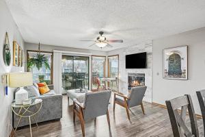 a living room with a couch and a table with chairs at Full Moon Condo in Lake Ozark
