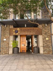 a entrance to a building with a sign on it at Mapungubwe Hotel Apartments Marshalltown in Johannesburg