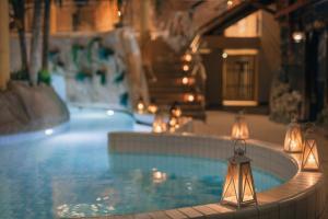 a swimming pool with lights in a building at Holiday Club Turun Caribia in Turku