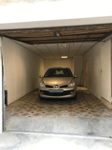 a car parked inside of a garage at L'OBIONE, maison centre ville in Saint-Gilles