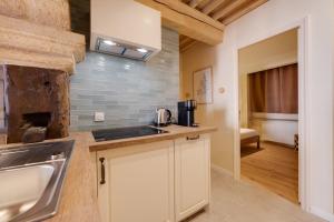 a kitchen with a sink and a counter top at Le Balcon Perrière I - Charming apartment with direct view of the Thiou in Annecy