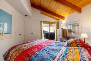 a bedroom with a bed with a colorful bedspread at Samson Getaway in Sea Ranch