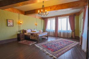 a bedroom with a bed and a large window at Knyazli Family Suites & Rooms in Kiçik Qaramurad