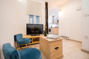 a living room with a television and two chairs at For You Rentals COZY APARTMENT IN BARRIO SALAMANCA JOG48 in Madrid