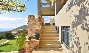 A balcony or terrace at Luxurious Villa Dionysus with a swimming pool and sea view