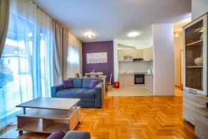 a living room with a couch and a table at Ambasador Zlatibor in Zlatibor