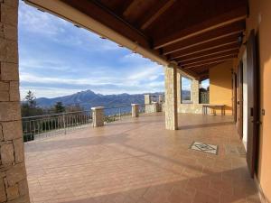an outdoor patio with a view of the mountains at La Terrazza Baldo Garda in San Zeno di Montagna