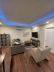 a living room with a couch and a table at Brand New 2BR CUTE Blue LED in North Fresno in Fresno