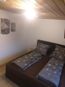 a bedroom with two beds in a room at Ferienwohnungen Eibner in Dettingen an der Erms +2 photos