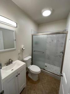 a bathroom with a shower and a toilet and a sink at Brand New 2BR CUTE Blue LED in North Fresno in Fresno