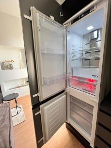 an empty refrigerator with its door open in a kitchen at Kibilù - Via Taormina - Ospedale Niguarda - Isola in Milan