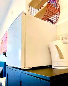 a kitchen with a toaster on a blue cabinet at Sea view cozy apartment in Haifa