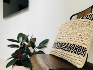 a basket sitting on a bench with a plant at URALLA STUDIO - South Coast - Private Guest Suite in Bomaderry