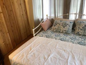 a bedroom with a bed with pillows and a window at Ruth House Original Craftsman PETS, walk to State st. in Santa Barbara