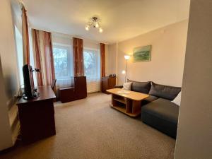a living room with a couch and a table at Alanta "Easy Kaunas" in Kaunas