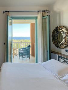 a bedroom with a bed and a view of the ocean at Park Hotel Asinara in Stintino