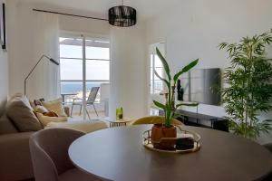 a living room with a table and plants at Apartment Manilva in Manilva