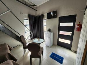 a living room with a couch and a table at 9 Levubu Cottages in Polokwane