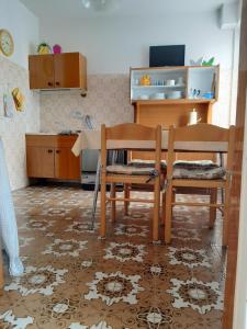 a dining room with two chairs and a table at Casa dei Tulipani Tenna Ospitar in Tenna 