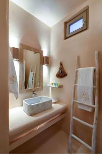 a bathroom with a sink and a mirror and a ladder at Executive Paros Villa Villa Avra Sea View and Outdoor Jacuzzi Villa Kostos Damouli in Kampos Paros