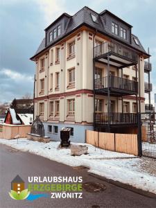 a large building with a black roof at Urlaubshaus-Erzgebirge in Zwönitz