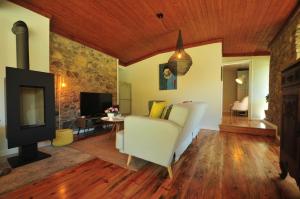 a living room with a couch and a fireplace at Casas de Santiago in Vila Nova de Cerveira