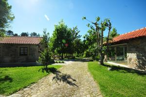 a stone path leading to a house with a yard at Casas de Santiago in Vila Nova de Cerveira
