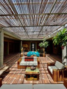 a patio with tables and couches in a building at Hotel Finca Del Café in Santa Rosa de Cabal