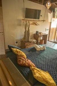 a bedroom with a bed with a fish shaped comforter at Riva del Sol Beach Resort in Santa Caterina dello Ionio