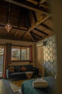 a living room with a bed and a couch at Riva del Sol Beach Resort in Santa Caterina dello Ionio