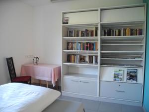een slaapkamer met een boekenplank gevuld met boeken bij Geräumiges Ferienhaus mit Garten und Weitblick ins Grüne in Oesterdeichstrich