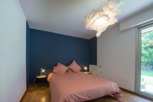 ein Schlafzimmer mit einem Bett und einer blauen Wand in der Unterkunft TY AR MENEZ - Grande maison familiale proche plage in Landunvez